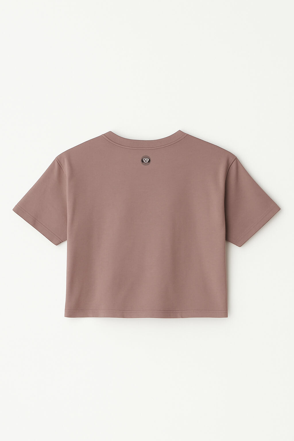 An Oversized Dog Mom Crop Top from Dogloverclothing.com, taupe and short-sleeved, is laid flat with the back facing up, featuring a small round logo near the upper center neckline.