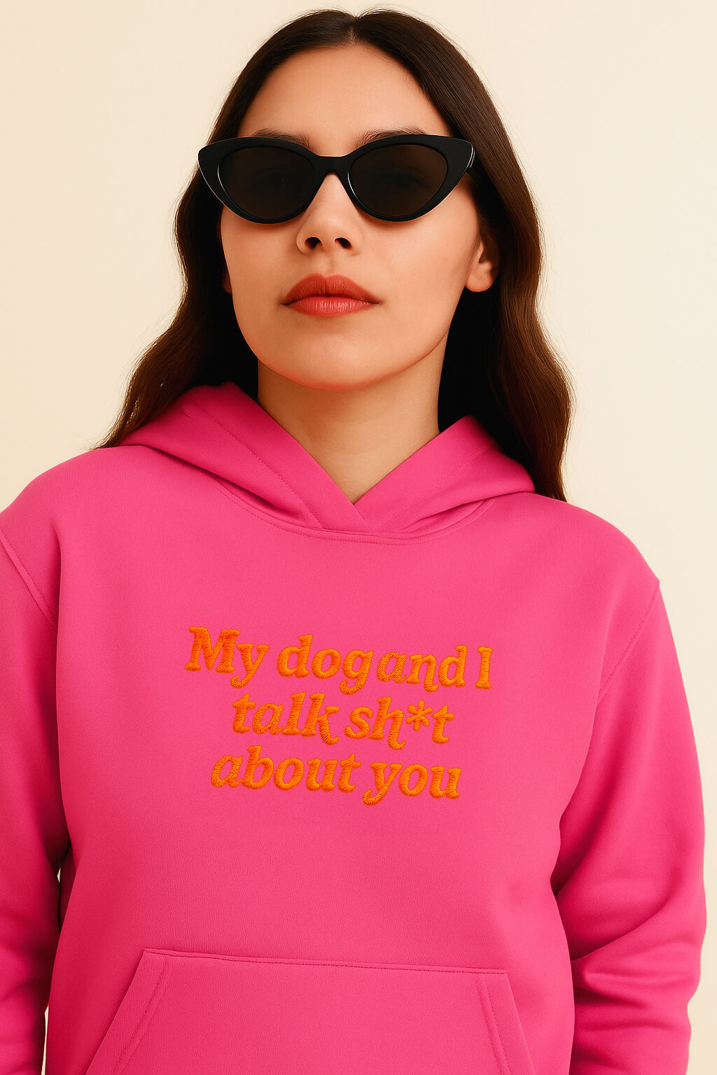 A woman in Dogloverclothing.coms Bold My Dog And I Talk Embroidered Hoodie—bright pink premium fabric with yellow text—wears black cat-eye sunglasses against a neutral background, offering all-day comfort.