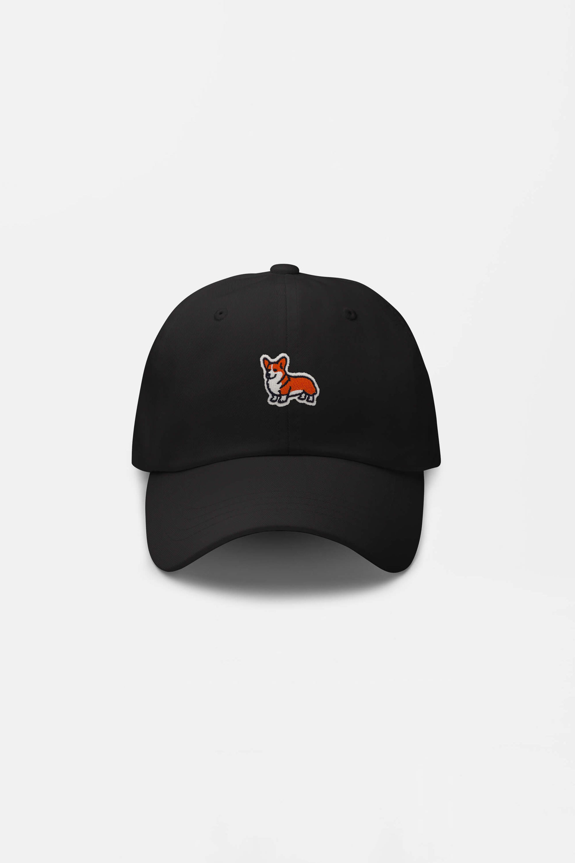 The Iconic Corgi Cap from Dogloverclothing.com is a black hat with a small embroidered orange and white corgi dog on the front—ideal for fans of Corgi cuteness and stylish headgear.