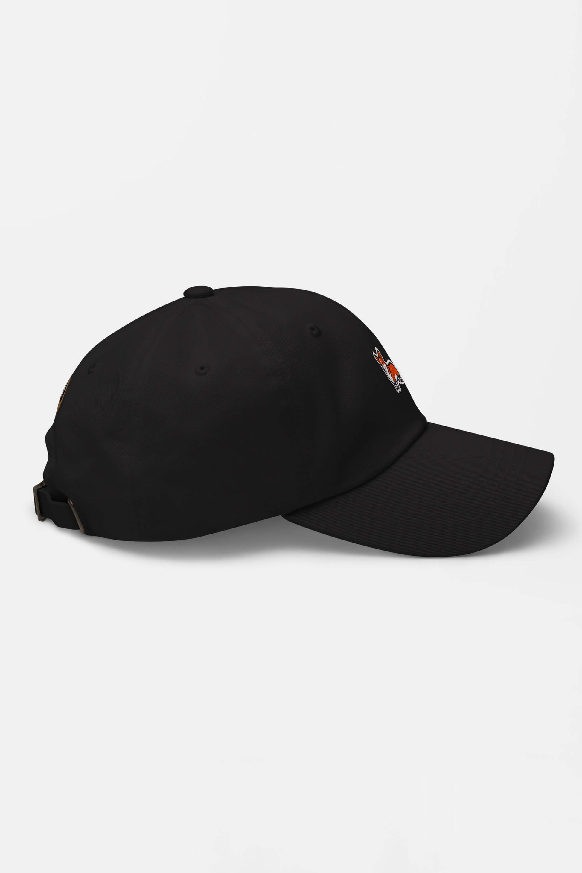The Iconic Corgi Cap by Dogloverclothing.com is a black cap with an adjustable strap and a small side embroidery, perfect for subtle Corgi style. Shown from the side on a plain white background.